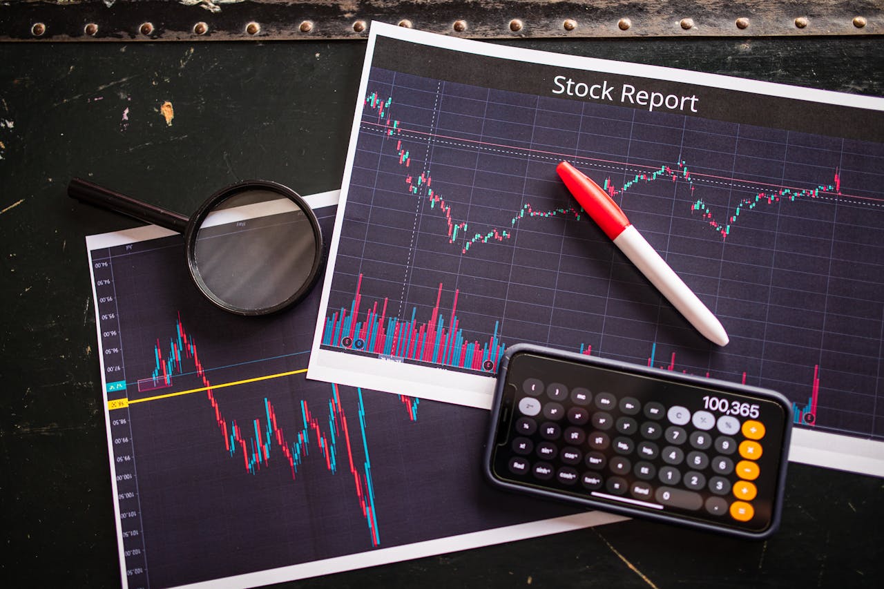 Stock report with charts, calculator, and magnifying glass for financial analysis.